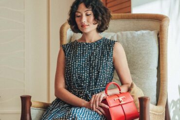 Max Mara Rosetta sleeveless belted midi dress from Saks Fifth Avenue. T Timeless bag from TOD’s.