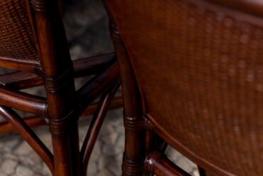 rattan close-up in a a dark lighting setting with cherry colored weave.
