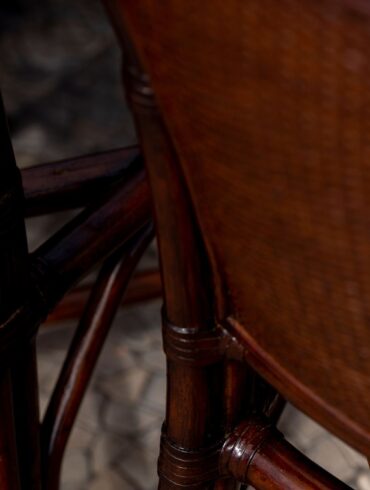 rattan close-up in a a dark lighting setting with cherry colored weave.