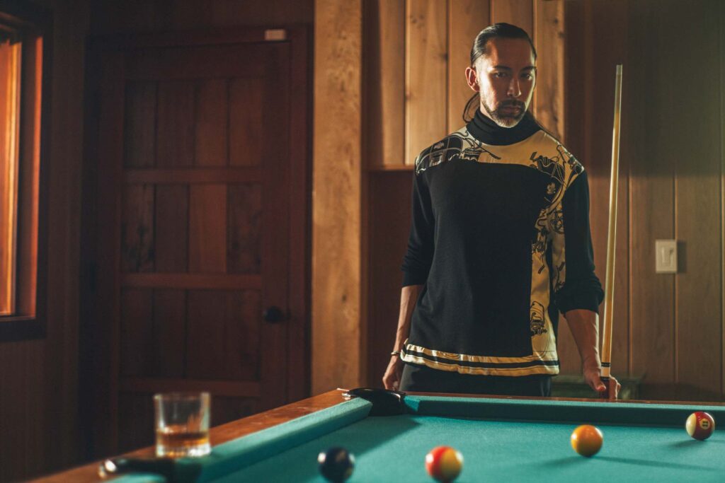 a person standing at a pool table
