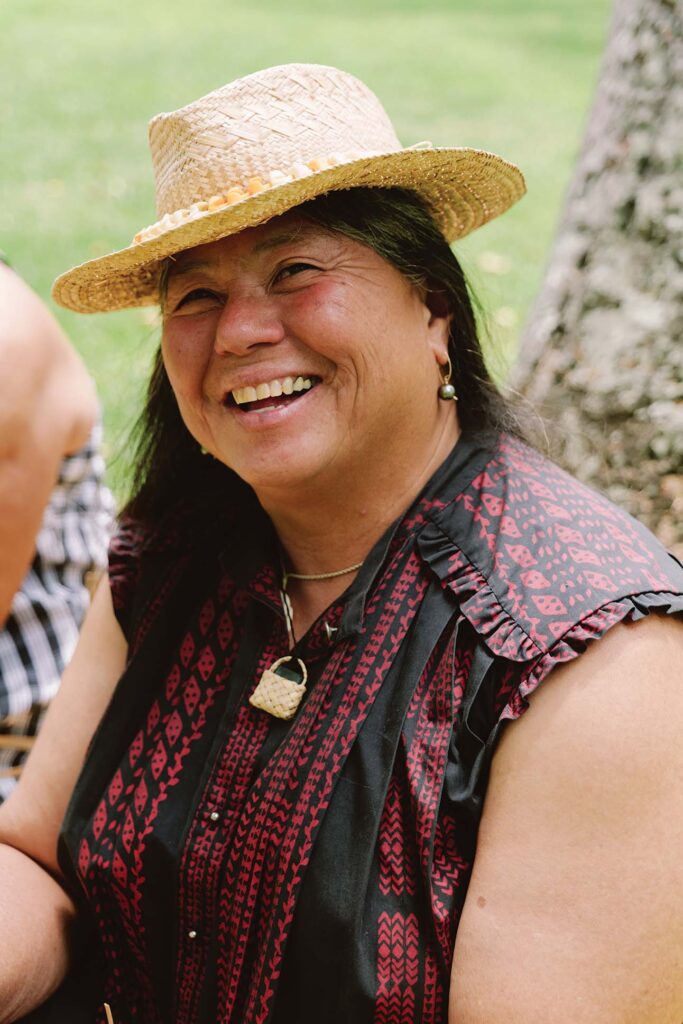 a person wearing a straw hat smiling