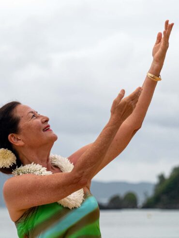 a person with her arms raised in the air