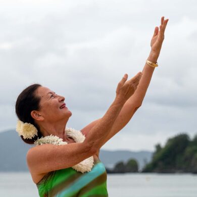 a person with her arms raised in the air
